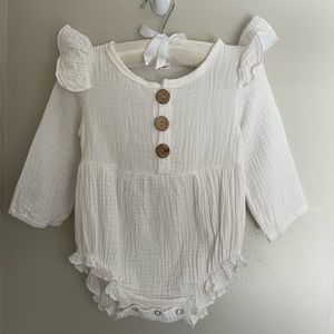 White long sleeve romper with ruffle shoulders, size 6m.